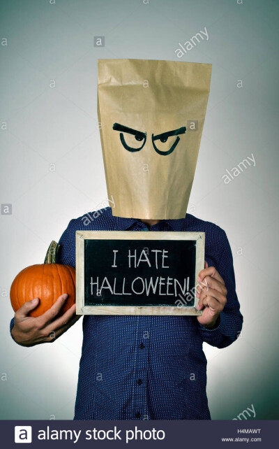a-young-man-with-a-paper-bag-in-his-head-with-a-funny-face-holds-a-H4MAWT.md.jpg